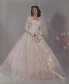 an old photo of a woman in a wedding dress