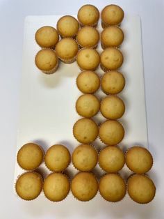 the letter k is made out of muffins on a white plate and placed next to each other