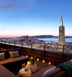 an outdoor lounge area overlooking the city lights