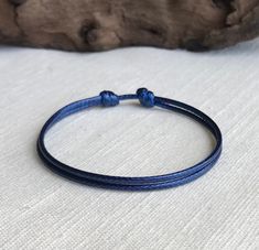 "Please choose size and quantity. This item is made with 1.5mm durable and waterproof waxed cord. This cord is a great waterproof alternative to leather. Each handmade bracelet and anklet is clasp-free and fits over the hand/foot. Bracelet is 6\" at smallest and opens to 11\". Anklet is 9\" at smallest and opens to 15\". Two sliding knots move to adjust size. Bracelet is pictured. Please see my store for a full jewelry line. I am happy to answer any questions :) This piece of jewelry is not made Affordable Blue Jewelry With Adjustable Cord, Adjustable Cord Bracelet, Foot Bracelet, Free Bracelet, Cord Bracelet, Sliding Knot, Cord Bracelets, Handmade Bracelet, Braided Bracelets