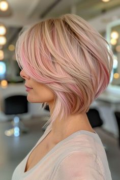 Short stacked blonde bob with pastel pink highlights, styled sleek with subtle waves Stacked Blonde Bob, Blonde And Pink Highlights, Pastel Pink Highlights, Blonde And Pink, Bob Hat, Stacked Bob Haircuts, Short Stacked Bob, Short Stacked Bobs, Chic Hairstyle