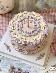 a pink cake sitting on top of a white plate