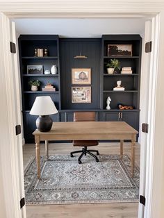 an office with built in bookcases and a desk