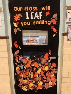 a door decorated with fall leaves and the words our class will leaf you smiling