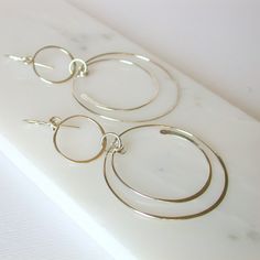 "Swinging circles and semi circles create these fun and unique earrings. Shown in sterling silver, also available in 14k gold fill and rose gold fill. Measure approximately 3\". All of my jewelry is made with sterling silver and gold fill wire and findings, nothing is plated and the craftsmanship is guaranteed, so feel secure in purchasing these earrings for yourself or as a special gift. I guarantee all of my work. All orders come packaged ready for gift giving. In order to keep down on waste, Modern Nickel-free Open Circle Hoop Earrings, Modern Circular Hoop Earrings For Anniversary, Modern Circle Hoop Earrings For Anniversary, Modern Hoop Earrings For Anniversary, Modern Anniversary Hoop Earrings, Modern Dangle Hoop Earrings For Anniversary, Modern Anniversary Dangle Hoop Earrings, Geometric Hoop Earrings, Earrings Round