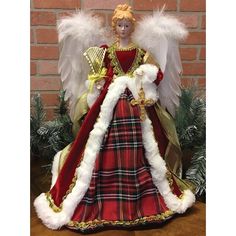 an angel figurine is dressed in red and white with gold trimmings