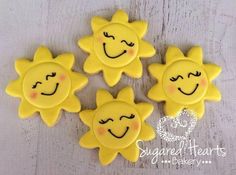 four sun cookies with faces drawn on them