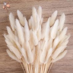 some white feathers sitting on top of a wooden table