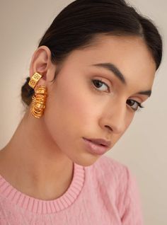 Editor's Note Handcrafted metal takes a mobile form in 22kt gold through the OH Poppi Spring Hoop earrings. Mimicking the playful movement of spring, the design finds the signature Poppi monogram crafted on bolts through the earrings for a play on dimensions. It’s an enticing clash of attitudes. Wear these modern works of art day, night and always in between! Material: Brass Plating: Gold Care: Store your jewelry in a box away from humidity or extreme surroundings. Use a dry cloth to clean it. A Charms Necklace, Hoops Gold, Brass Hoops, Mini Hoop Earrings, Girl Jewelry, Pearl Hoop Earrings, Online Earrings, Baroque Pearls, 22k Gold