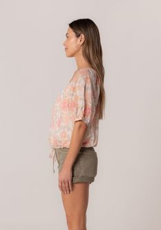 A charming short puff sleeve blouse in a natural and pink floral print. Floral print Cotton Relaxed fit Short puff sleeve Elastic cuff Scoop neckline Self-covered button front Adjustable drawstring waist with ties Lined Lightweight summer blouse Made with lightweight cotton, this spring blouse is perfect for any occasion. Designed in a pink floral print, with a scoop neckline and a relaxed fit. The short puff sleeves add a playful touch and make this blouse perfect for spring and summer. Model i Feminine Floral Print Short Sleeve Top, Feminine Short Sleeve Floral Print Top, Spring Floral Print Puff Sleeve Top, Feminine Floral Print Relaxed Tops, Feminine Floral Print Top With Relaxed Fit, Floral Print Puff Sleeve Tops For Daywear, Casual Floral Print Puff Sleeve Top For Summer, Casual Puff Sleeve Top With Floral Print For Summer, Casual Spring Floral Print Puff Sleeve Top