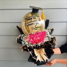 someone is holding a graduation balloon with flowers in it and congratulations written on the balloon