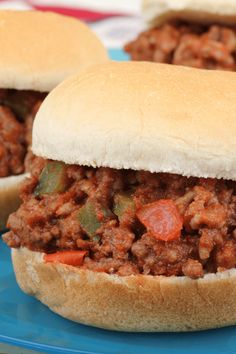 two sloppy joe sandwiches on a blue plate