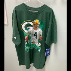 This Vintage Nfl Reebok T-Shirt Is Brand New Nfl Merchandise. It Features Brett Favre And The Authenticity Sticker Is On The Sleeve. There Is Also A Tag Attached Where Are You Can Send In Contact Information To The Nfl Shop. The Shirt Is 100% Cotton. Own A Piece Of History! #Vintage Crew Neck Tops With Front Print For Fan Gear, Graphic Tee Sports Shirt In Green, Casual Green T-shirt For Fan Gear, Green Sports Season T-shirt For Fan Gear, Green T-shirt For Sports Season Fan Gear, Green Relaxed Fit Tops For Sports Season, Green Fan Merchandise T-shirt For Sports Season, Green Crew Neck Top For Fans, Nfl Merchandise