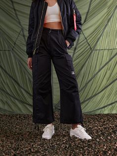 These cargo-style pants are modeled after the US Army M-65 field uniform, one of the most classic military styles to date. The pants include side cargo pockets, drawstring hems, and a double closure waistband for extra security. FEATURES waistband with button and zipper closure drawstring at hem cargo pocket at side seams with hidden snap closure patch pockets on back nylon belt loop detail on wearers left d-ring with alpha red ribbon attached to wearers left back belt loop Military Style Fashion, Gift Guide Women, Giving Tuesday, Cargo Style, Cargo Pocket, Style Pants, Cargo Pant, Military Style, Red Ribbon