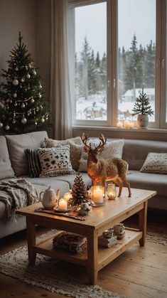 a living room with a christmas tree and candles on the coffee table in front of it