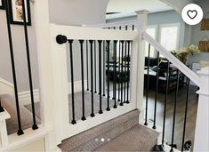 the stairs in this house are made of wood and wrought iron railings with black posts