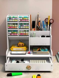 a white shelf filled with lots of craft supplies