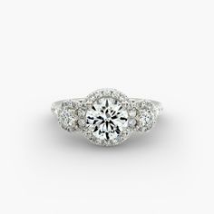 an engagement ring with three stones on the side and a center stone in the middle