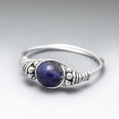 This ring is uniquely hand-crafted with 22 gauge sterling silver round wire, 4x5mm sterling silver Bali beads, and a 6mm Sodalite round bead. I make this ring to order. The ring pictured is a representation of what you will receive. **The photos make the beads look much larger than they actually are.** If you would like a combination of beads that you don't see listed, please inquire! Sodalite Jewelry, Silver Wire Rings, Raw Crystal Ring, Blue Gemstone Rings, Sterling Silver Wire Wrap, Chakra Jewelry, Cabochon Ring, Handmade Rings, Beaded Rings