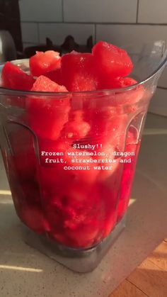 a blender filled with red liquid on top of a counter