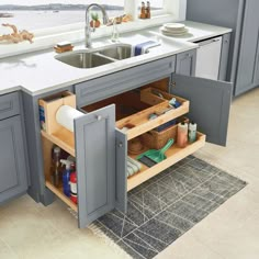 a kitchen with gray cabinets and white counter tops