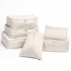 four bags are stacked on top of each other and one bag is filled with pillows