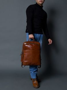 Make a bold statement with this head-turning Italian brown leather backpack that radiates confidence and style. The glossy finish enhances its vibrant color, creating a mesmerizing and eye-catching accessory. The sleek design and luxurious feel of the leather makes it a standout piece in any fashion ensemble, promising to elevate your look with a touch of glamour. Whether you're navigating city streets or making a grand entrance at an event, this bold and eye-catching brown leather backpack is t Leather Bags With Glossy Finish For Daily Use, Daily Use Leather Bags With Glossy Finish, Modern Travel Bags With Glossy Finish, Classic Glossy Travel Bag, Daily Use Glossy Leather Bags, Modern Glossy Travel Bag, Modern Glossy Finish Travel Bags, Modern Business Bags With Glossy Finish, Modern Glossy Business Bags