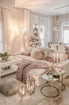 a living room filled with white furniture and a christmas tree in the middle of it