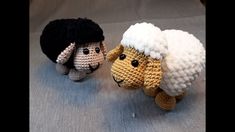 two crocheted sheep are standing next to each other