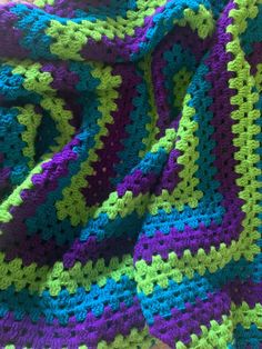 there is a crocheted blanket that looks like it has been made with yarn