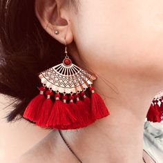 These unique bohemian fan tassel earrings feature red fan tassel on metal fan charm. Add these unique boho fan tassel dangle drop statement earrings to your everyday fashion earrings collection or as gift for your love one. Materials: mettal, cotton tasselFinish: rose gold color Jewelry Care: See more information about how to care for your jewelry here. Shipping Policy: Orders will be shipped within 1-3 business days. Economy shipping will take 7-14 days to arrive and standard shipping is 1- 4 d Metal Tassel Fringe Drop Earrings, Bohemian Metal Tassel Earrings For Party, Elegant Red Tassel Earrings For Summer, Tassel Metal Earrings For Festival, Metal Tassel Earrings For Festival, Handmade Trendy Red Tassel Earrings, Festival Tassel Earrings With Fringe, Red Metal Earrings For Summer, Red Fringe Tassel Earrings For Summer