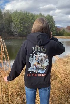 This hoodie is designed with the outdoorswoman in mind. Crafted from high-quality materials, it features a Labrador Retriever graphic and For the Thrill of the Hunt quote. Enjoy all your favorite outdoor activities in comfort and style. Introducing our Gildan Ultimate Heavy Blend Hoodie for cozy comfort! Being designed for everyday wear, this hoodie is made from a premium 50/50 cotton-polyester blend, enhancing durability, while also staying super comfortable. This cozy  hoodie provides warmth, a soft feel, and long-lasting comfort and durability.      The hood is double-lined with drawstrings for added warmth and an adjustable fit. Its double-needle stitching on the cuffs and waistband provides extra durability, while the spacious front pouch pocket offers convenience and functionality. T Cute Western Hoodies, Hooded Sweatshirt With Kangaroo Pocket For Hiking, Fall Camping Hooded Jacket With Adjustable Hood, Hoodie Sweatshirt For Outdoor Activities, Hooded Sweatshirt With Kangaroo Pocket For Outdoor Activities, Hooded Sporty Sweatshirt For Hiking, Sporty Hooded Sweatshirt For Hiking, Hooded Hoodie With Kangaroo Pocket For Hiking, Fleece Hoodie With Adjustable Hood For Hiking