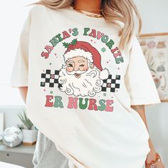 a woman wearing a santa's favorite er nurse t - shirt