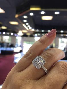 a woman's hand with a diamond ring on it