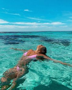 a woman floating in the ocean with her head above water