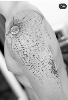 a man with a tattoo on his arm that has an image of a space shuttle in it