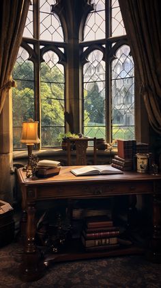 a desk in front of a large window with lots of books on top of it