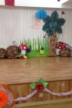 the stage is set up for a children's birthday party with decorations and flowers