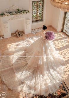 a woman in a wedding dress is standing on the floor