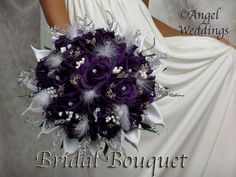 a bridal bouquet with purple flowers and feathers