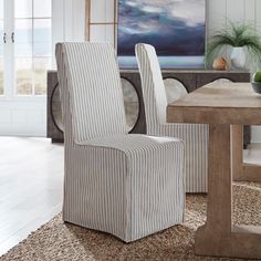 a striped chair sitting in front of a wooden table