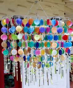 a chandelier with many different colored discs hanging from it