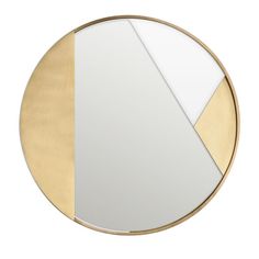 a round mirror with gold and white panels on the outside, in front of a white background