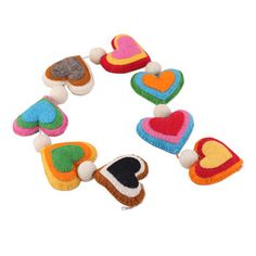 multicolored felt heart shapes are arranged in a circle on top of each other