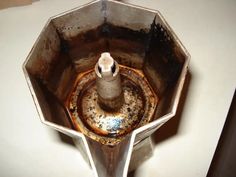 an old metal object sitting on top of a table