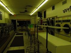 an empty laundry room filled with washers and dryers