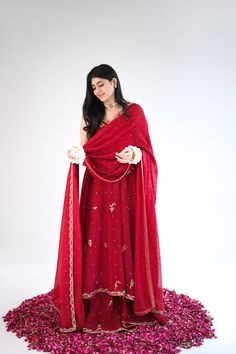 Designed on a beautiful tone of maroon in handloom cotton net, this panelled kalidaar features gold ada work of dabka naqshi, sequins and nug. An alluring three piece is paired with a heavily embellished dupatta and flappers. The length of the kalidaar is 46 inches. Order Duration: 4 to 6 weeks Anarkali Jamawar Sharara With Zari Work, Anarkali Style Sharara In Jamawar With Zari Work, Traditional Floor-length Unstitched Suit With Dupatta, Festive Floor-length Jamawar Sharara, Unstitched Anarkali Set With Mirror Work For Festive Occasions, Festive Jamawar Lehenga With Dabka Work, Bollywood Style Dabka Lehenga In Jamawar, Zari Work Anarkali Set In Dola Silk, Designer Jamawar Lehenga With Mirror Work