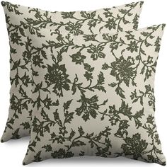 two green and white pillows with leaves on them