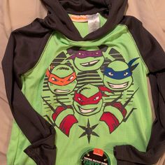 Ninja Turtle Long Sleeve Shirt Boys Size 8 Nwt Casual Hooded Top With Character Print, Sporty Long Sleeve Tops With Character Print, Green Long Sleeve T-shirt With Character Print, Green Hooded Top With Graphic Print, Casual Long Sleeve Tops For Playtime, Black Long Sleeve Tops For Playwear, Winter Character Print Long Sleeve Tops, Playful Green Tops For Winter, Winter Long Sleeve Tops With Character Print