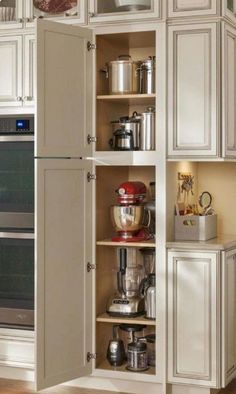 an open cabinet in the corner of a kitchen